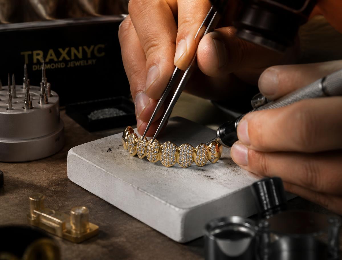 Jeweler setting stones into a gold dental piece